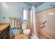 This bathroom features a shower, a window, and a toilet with neutral blue walls, offering a simple design at 2817 Rustic Oaks Dr, Palm Harbor, FL 34684