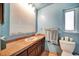 Bathroom with single sink vanity and toilet at 2817 Rustic Oaks Dr, Palm Harbor, FL 34684