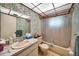 This bathroom features wallpaper with plants and a bathtub with shower that offers a tranquil escape at 2817 Rustic Oaks Dr, Palm Harbor, FL 34684