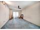 Bedroom features a ceiling fan, carpet and sliding glass door access at 2817 Rustic Oaks Dr, Palm Harbor, FL 34684