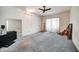 Bedroom features a ceiling fan, carpet and sliding glass door access at 2817 Rustic Oaks Dr, Palm Harbor, FL 34684