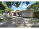 Charming home exterior featuring stone archway, well-manicured landscaping and walkway, and a two car garage at 2817 Rustic Oaks Dr, Palm Harbor, FL 34684