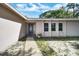 Inviting front porch with an American flag on the door and a view of the surrounding yard at 2817 Rustic Oaks Dr, Palm Harbor, FL 34684