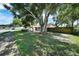 Charming single-story home with stone accents, a large shade tree, and a well-maintained lawn in a quiet neighborhood at 2817 Rustic Oaks Dr, Palm Harbor, FL 34684