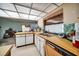 The kitchen features ample counter space, stainless steel sink, and vintage appliances at 2817 Rustic Oaks Dr, Palm Harbor, FL 34684