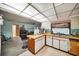 This kitchen features a breakfast bar area that opens to the living room at 2817 Rustic Oaks Dr, Palm Harbor, FL 34684