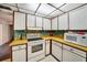 The kitchen features white appliances and colorful backsplash at 2817 Rustic Oaks Dr, Palm Harbor, FL 34684