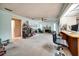 The carpeted living room features a fireplace, shelves, and a desk area at 2817 Rustic Oaks Dr, Palm Harbor, FL 34684