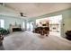 Open-concept living area with a cozy fireplace and bar seating connecting to the kitchen, ideal for entertaining guests at 2817 Rustic Oaks Dr, Palm Harbor, FL 34684