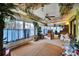 This sunroom has decor and plants to offer a sun-kissed retreat inside this home at 2817 Rustic Oaks Dr, Palm Harbor, FL 34684