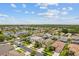 Aerial view of a quiet neighborhood with tree-lined streets and a picturesque lake at 3013 Silvermill Loop # O, Land O Lakes, FL 34638