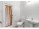 Bathroom featuring a toilet, sink, and door with a curtain rod at 3013 Silvermill Loop # O, Land O Lakes, FL 34638