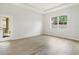Bright bedroom with laminate flooring, natural light, and access to the porch at 3013 Silvermill Loop # O, Land O Lakes, FL 34638
