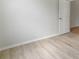 Neutral bedroom space with hardwood floors and white door at 3013 Silvermill Loop # O, Land O Lakes, FL 34638