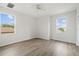 Bedroom with hardwood floors and two windows providing natural light and a view of the outdoors at 3013 Silvermill Loop # O, Land O Lakes, FL 34638