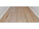 Hardwood flooring shown in horizontal angle with white baseboards in a room with white walls at 3013 Silvermill Loop # O, Land O Lakes, FL 34638