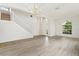 Inviting living room with light wood floors, a chandelier, and a staircase at 3013 Silvermill Loop # O, Land O Lakes, FL 34638
