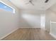 An airy room with light hardwood floors, a window with a view, a ceiling fan, and white walls at 3013 Silvermill Loop # O, Land O Lakes, FL 34638