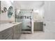 Modern bathroom featuring double sinks, elegant tile flooring, and a glass-enclosed shower at 30247 Emmetts Ct, Wesley Chapel, FL 33543