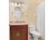 Bathroom with a granite countertop, cherry vanity, and a shower with curtain at 30247 Emmetts Ct, Wesley Chapel, FL 33543