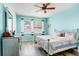 Bright bedroom featuring a ceiling fan, natural light, and calming blue walls at 30247 Emmetts Ct, Wesley Chapel, FL 33543