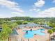 A clover-shaped community pool surrounded by palm trees offers a refreshing escape at 30247 Emmetts Ct, Wesley Chapel, FL 33543