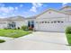 Well-maintained home with a lush green lawn and a spacious driveway at 30247 Emmetts Ct, Wesley Chapel, FL 33543