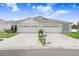 Charming duplex featuring a well-manicured lawn and a double garage at 30247 Emmetts Ct, Wesley Chapel, FL 33543