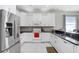 Modern kitchen with white cabinets, stainless steel appliances, and granite countertops at 30247 Emmetts Ct, Wesley Chapel, FL 33543