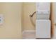 Compact laundry area featuring a stacked washer and dryer unit at 30247 Emmetts Ct, Wesley Chapel, FL 33543