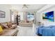 Bright living room showcasing tile floors and an open floor plan leading to outdoor patio at 30247 Emmetts Ct, Wesley Chapel, FL 33543