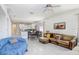 Open-concept living area with dining and kitchen, featuring tile floors and plenty of space at 30247 Emmetts Ct, Wesley Chapel, FL 33543