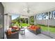 Cozy screened patio with comfortable seating and views of the lush backyard at 30247 Emmetts Ct, Wesley Chapel, FL 33543