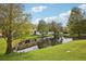Backyard featuring a pond and lush green grass at 30352 Elderwood Dr, Wesley Chapel, FL 33543