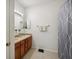 Bathroom featuring double sinks, wooden cabinets, neutral colors, and a shower/tub combo at 30352 Elderwood Dr, Wesley Chapel, FL 33543
