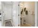 Bathroom featuring pedestal sink, decorator mirror and towel rack next to the front door at 30352 Elderwood Dr, Wesley Chapel, FL 33543