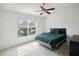 Bedroom with ceiling fan and a large window that lets in ample natural light at 30352 Elderwood Dr, Wesley Chapel, FL 33543
