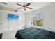 Bedroom featuring a TV, large closet and a large window providing a view at 30352 Elderwood Dr, Wesley Chapel, FL 33543