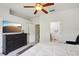 Spacious bedroom featuring a ceiling fan, large dresser, and access to an en-suite bathroom at 30352 Elderwood Dr, Wesley Chapel, FL 33543