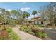 Clubhouse along a landscaped walkway with palm trees at 30352 Elderwood Dr, Wesley Chapel, FL 33543