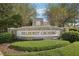Stone entrance sign to Hillhurst Crossing community with manicured landscaping and seating at 30352 Elderwood Dr, Wesley Chapel, FL 33543