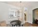Charming dining area with modern light fixture and views into the kitchen and hallway at 30352 Elderwood Dr, Wesley Chapel, FL 33543