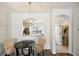Inviting dining area featuring modern lighting, dark table, and views of the kitchen and bathroom at 30352 Elderwood Dr, Wesley Chapel, FL 33543