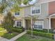 Inviting townhome featuring a well-manicured lawn, manicured bushes and attractive front entrance at 30352 Elderwood Dr, Wesley Chapel, FL 33543