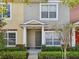 Charming townhome with landscaped front and inviting covered entryway with attractive door at 30352 Elderwood Dr, Wesley Chapel, FL 33543
