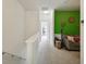 Hallway leading to a colorful living room with brightly painted accent wall at 30352 Elderwood Dr, Wesley Chapel, FL 33543