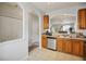 Spacious kitchen with stainless steel dishwasher and sink overlooking the living room at 30352 Elderwood Dr, Wesley Chapel, FL 33543