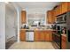 Bright kitchen with stainless steel appliances and a pass-through to the living room at 30352 Elderwood Dr, Wesley Chapel, FL 33543