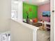 Bright living room with multicolored accent wall, TV, and gray sofa at 30352 Elderwood Dr, Wesley Chapel, FL 33543