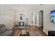 Inviting view of living and dining rooms with wood floors and archway to kitchen at 30352 Elderwood Dr, Wesley Chapel, FL 33543